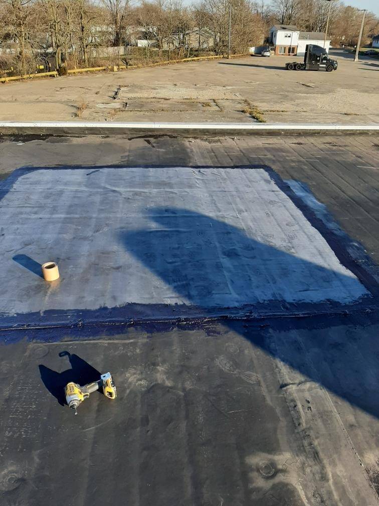 A repair in progress on the membrane of a flat commercial roof