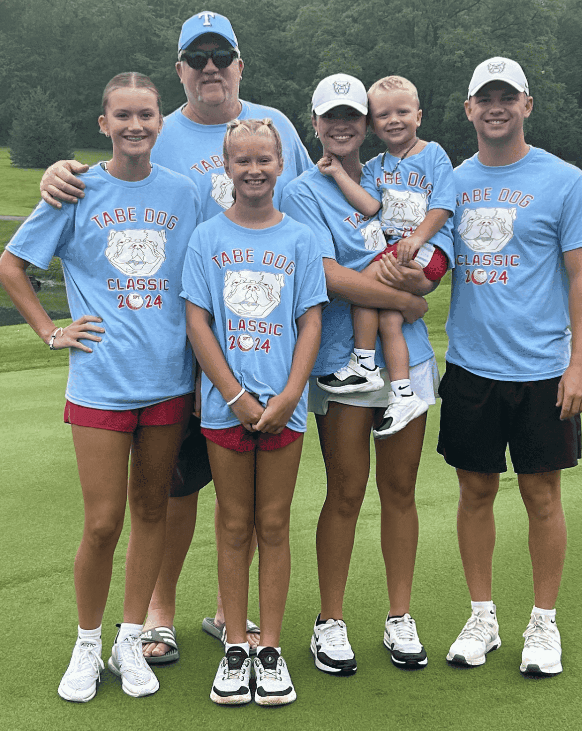 Shawn Tabor, who answers the phone and writes every estimate, with his nieces and nephews